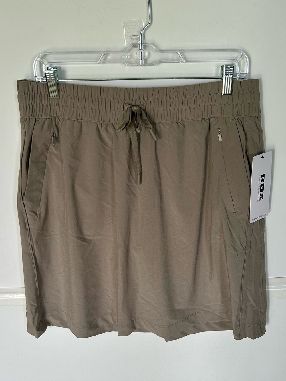 RBX Woman’s skort in Taupe with Drawstring Elastic Waist. Has zip pockets.